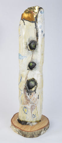 Beyond, ceramic with gold leaf, feathers and fur on a birch cut sculpture by Cerulean Arts Collective member Damini Celebre